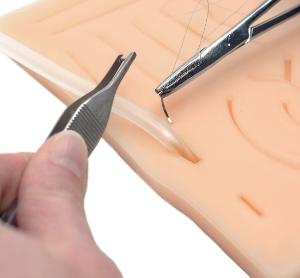 Suture practice pad with tube